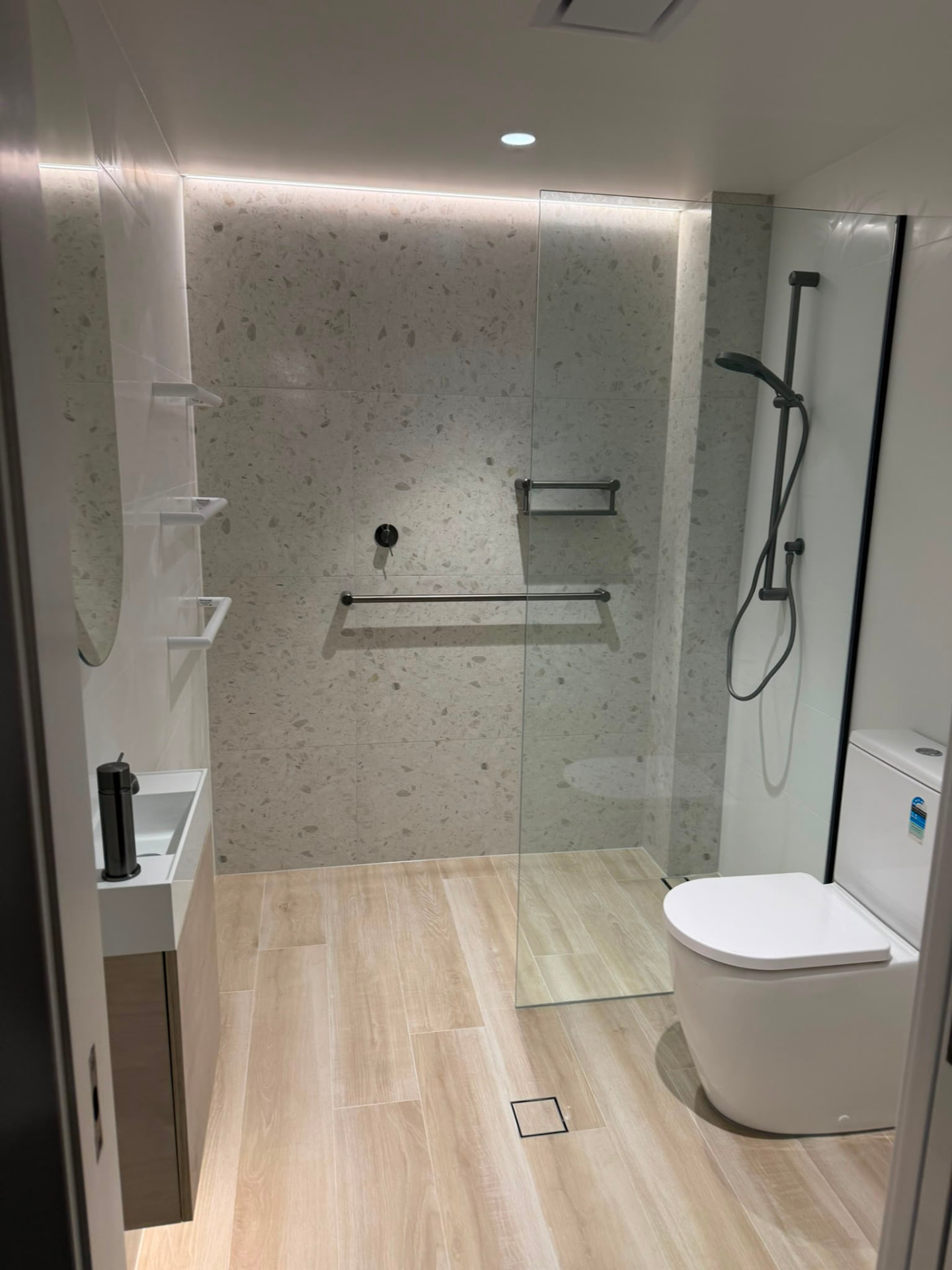 Terrazzo-tiled walk-in shower in a completed Porter Construction Group bathroom