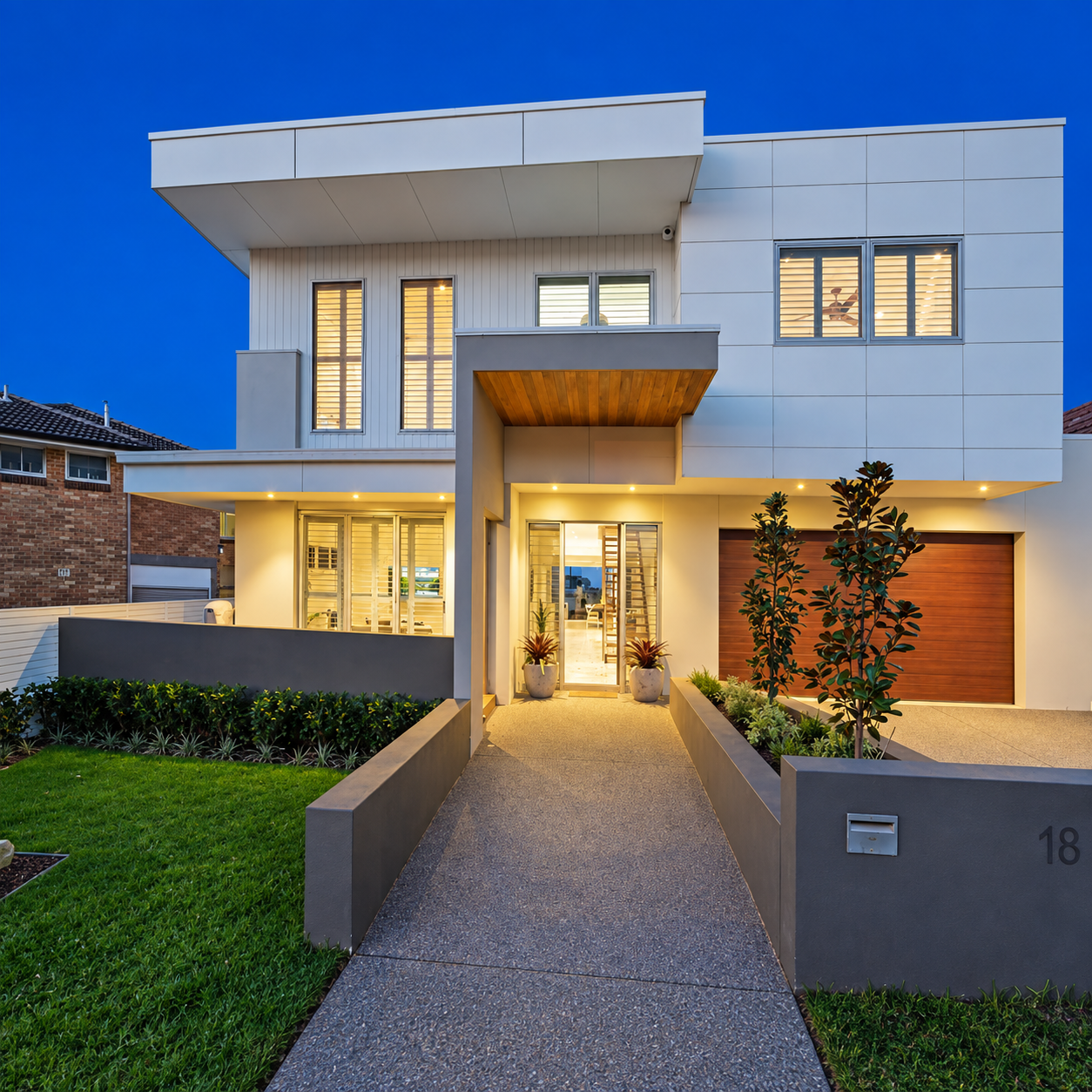 Contemporary two-storey home built by Porter Construction Group at dusk